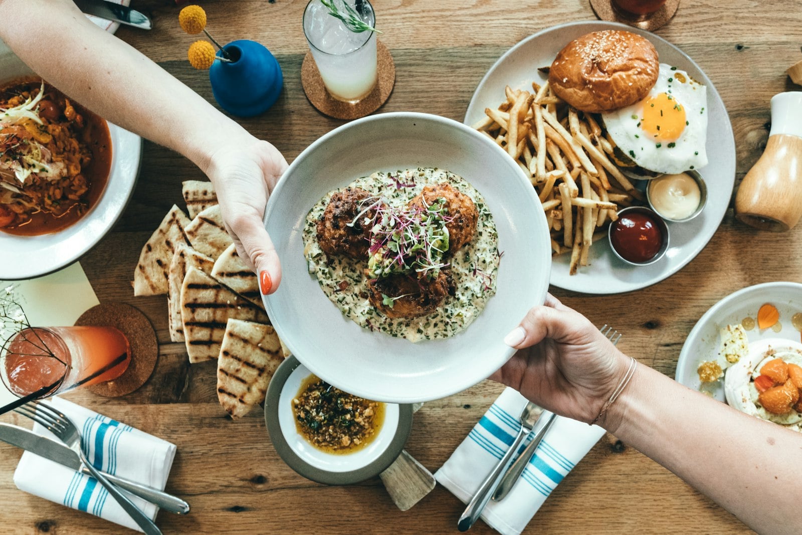 A plate of food carried to a table in a small neighborhood restaurant