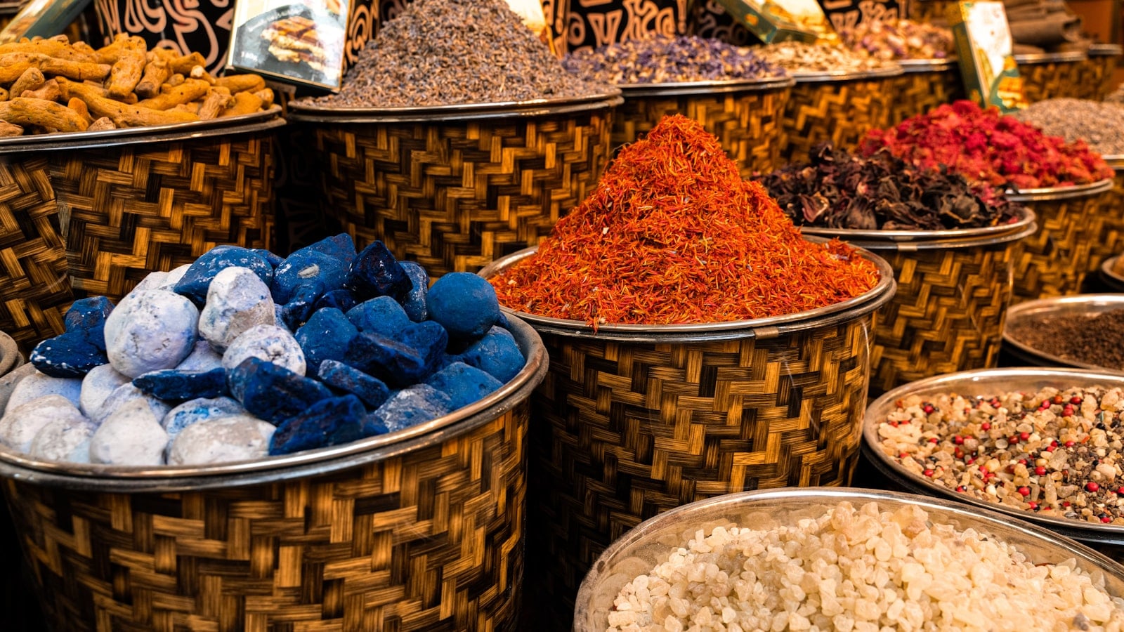 Woven market baskets filled with colorful spices and dried goods
