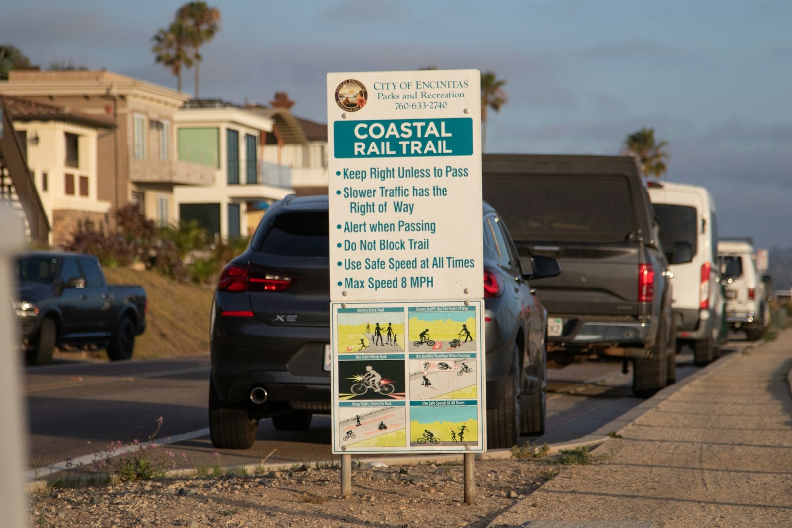 A City of Encinitas Coastal Rail Trail sign beside the road in Cardiff
