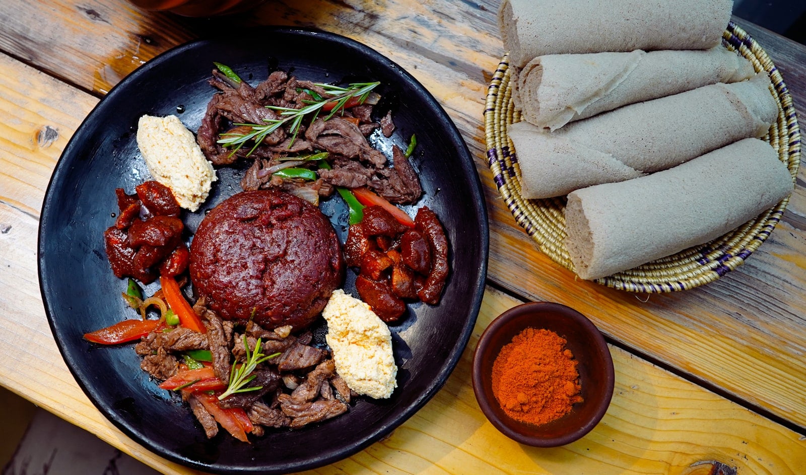 Injera platter with stews and vegetables at an Ethiopian restaurant