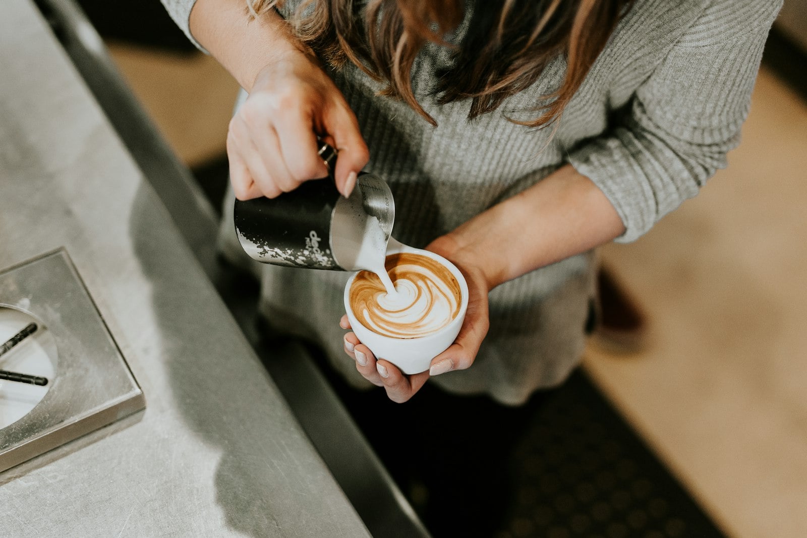 A laptop and coffee on a roomy San Diego cafe table
