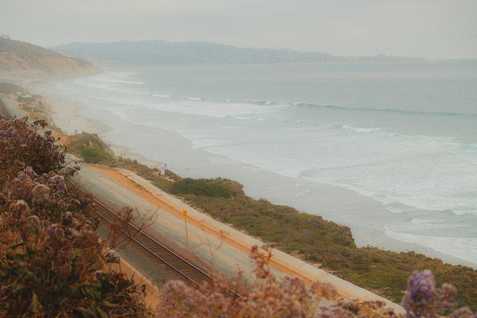 Del Mar beach and sandstone bluffs in late-day light