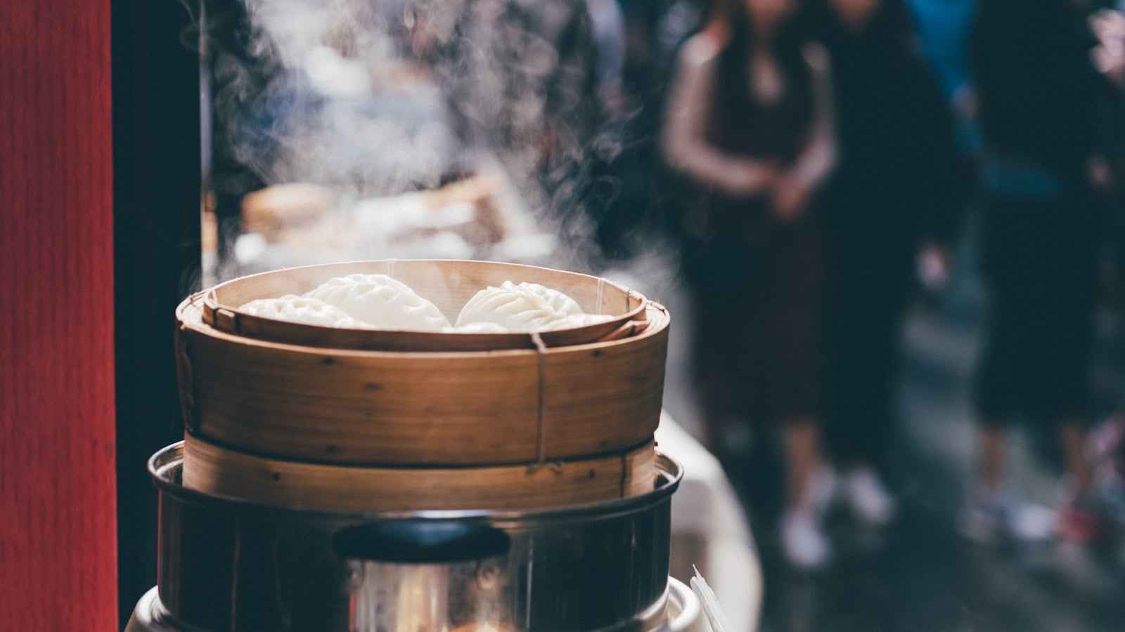 Bamboo steamers of har gow and siu mai crowding a dim sum table