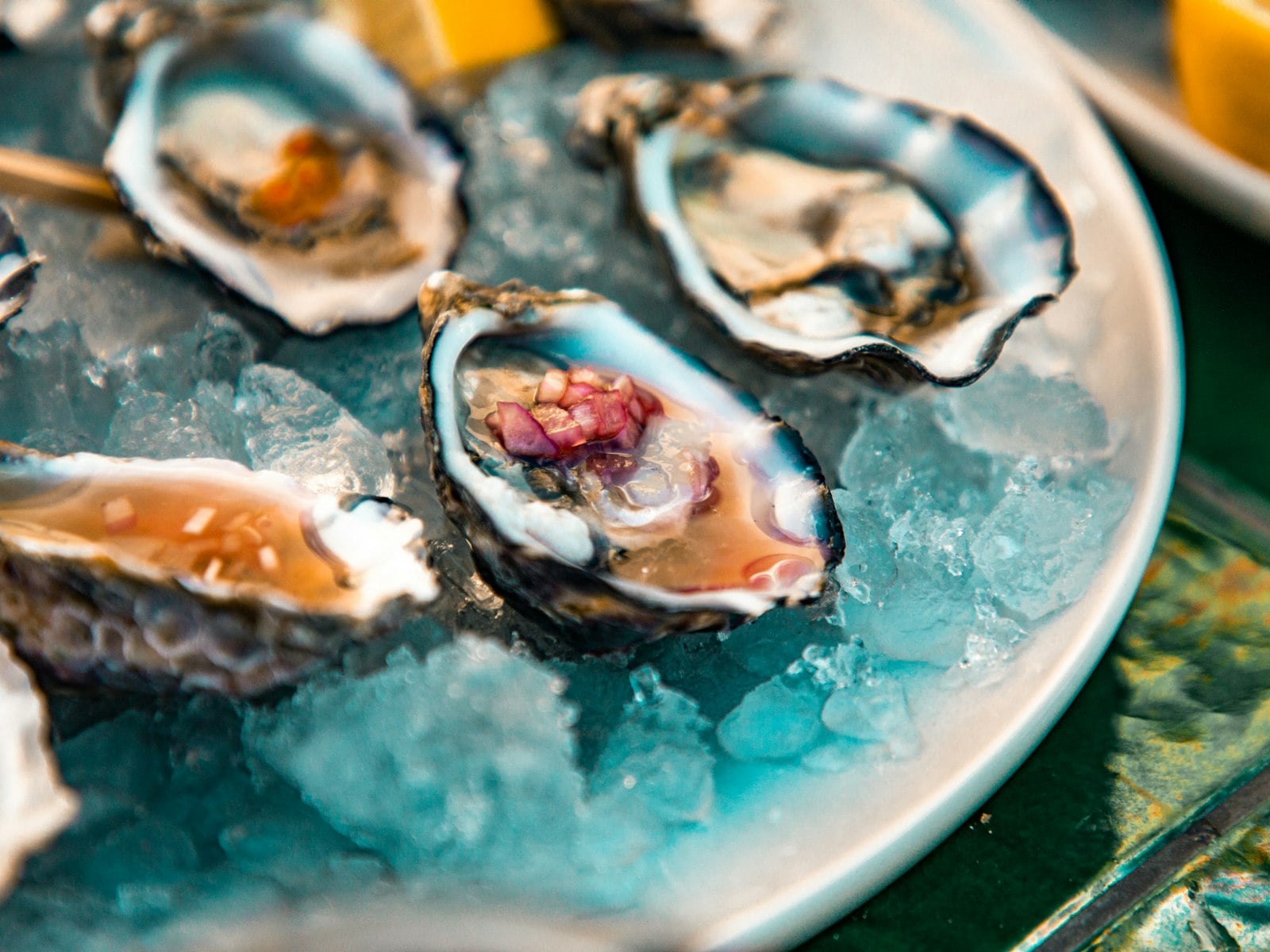 Oysters and cocktails arranged on a table during happy hour