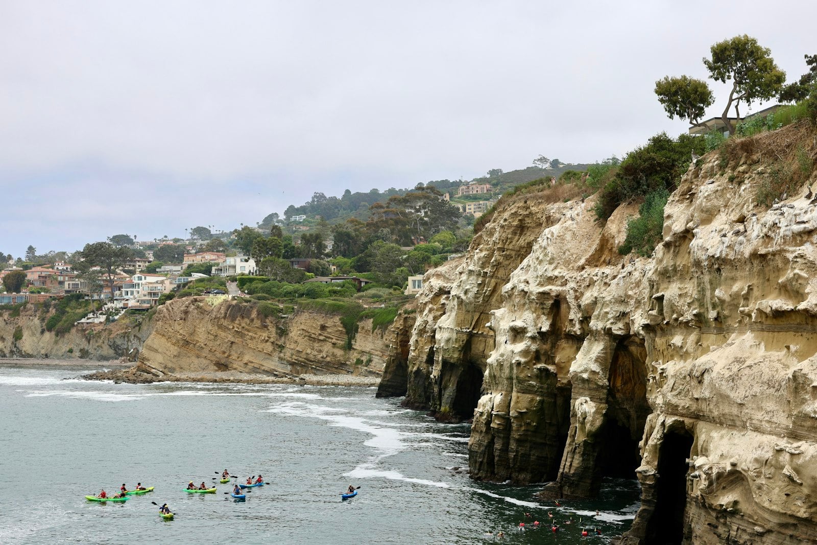 Kayaks launching from La Jolla Shores toward the sea caves