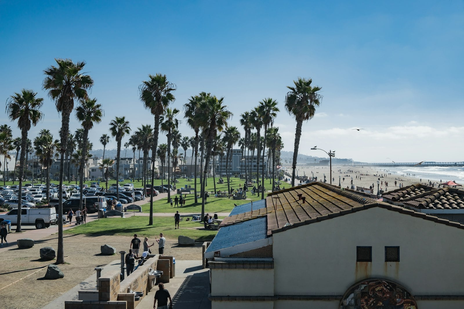 A restored Spanish Revival naval building on a landscaped campus in San Diego