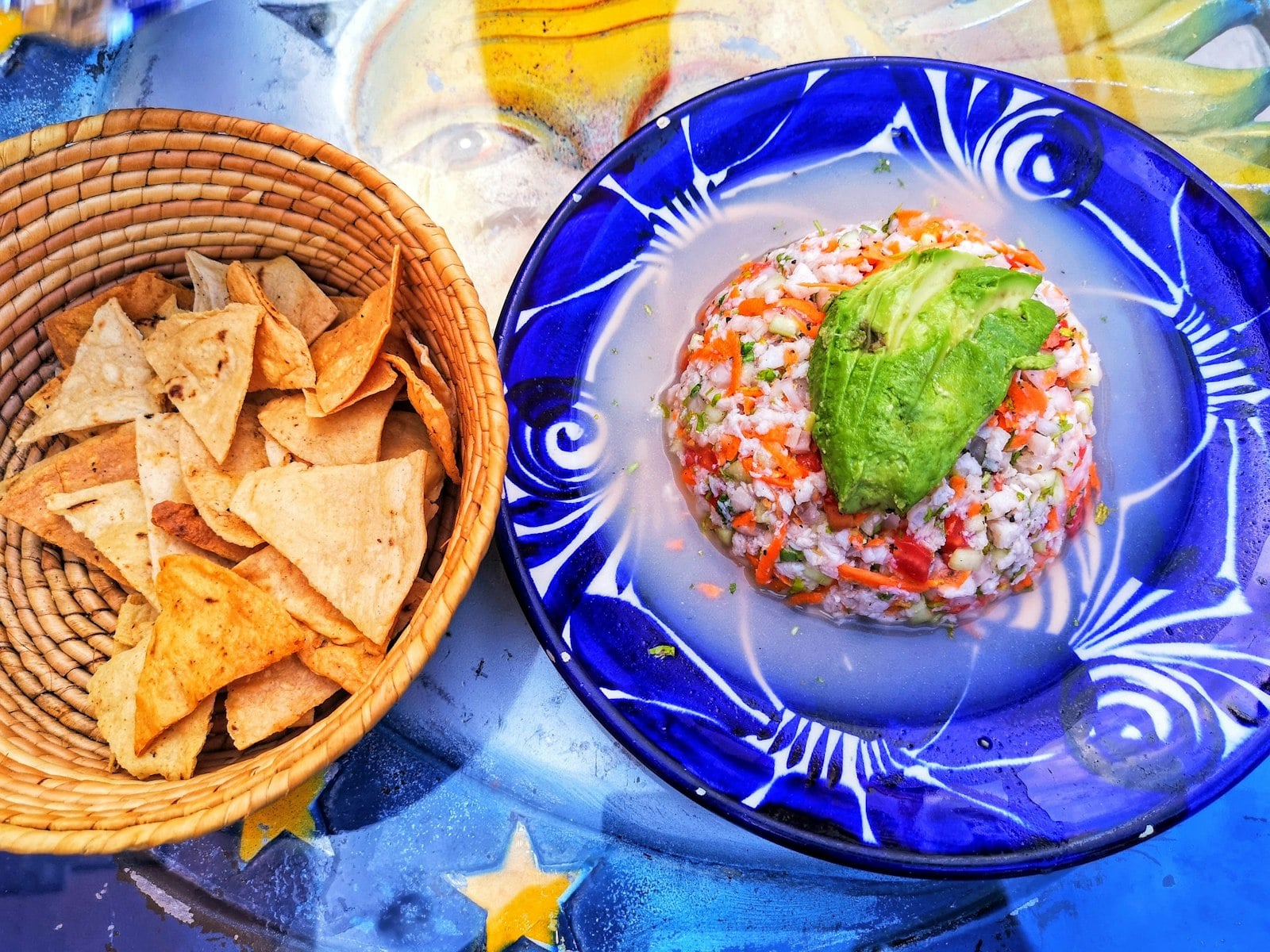 Ceviche tostada with avocado, lime, chile, and fresh seafood