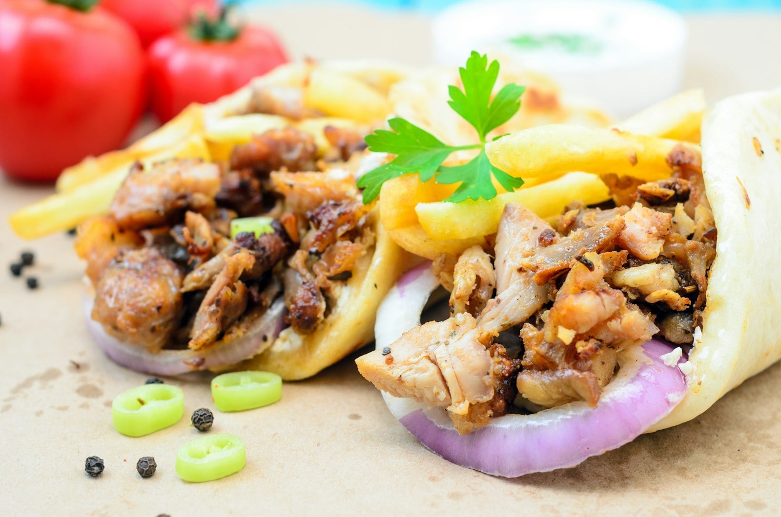 Shawarma carved from a vertical spit into fresh flatbread
