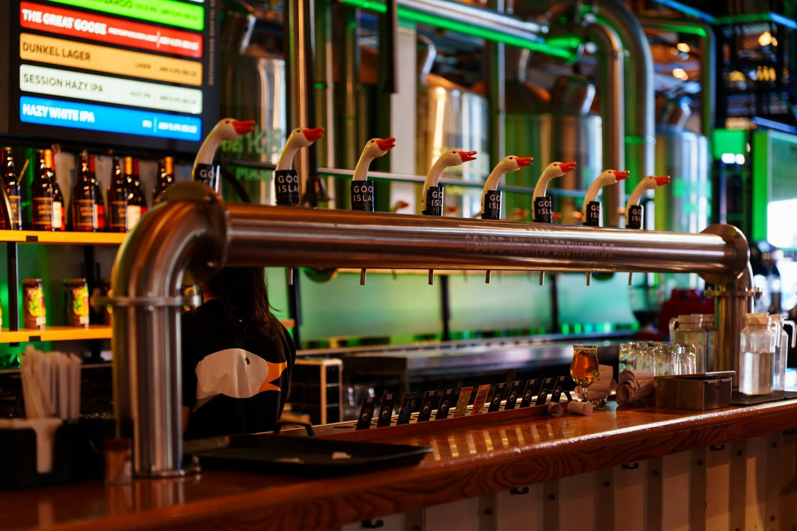 Beer taps and bottles behind a taproom bar