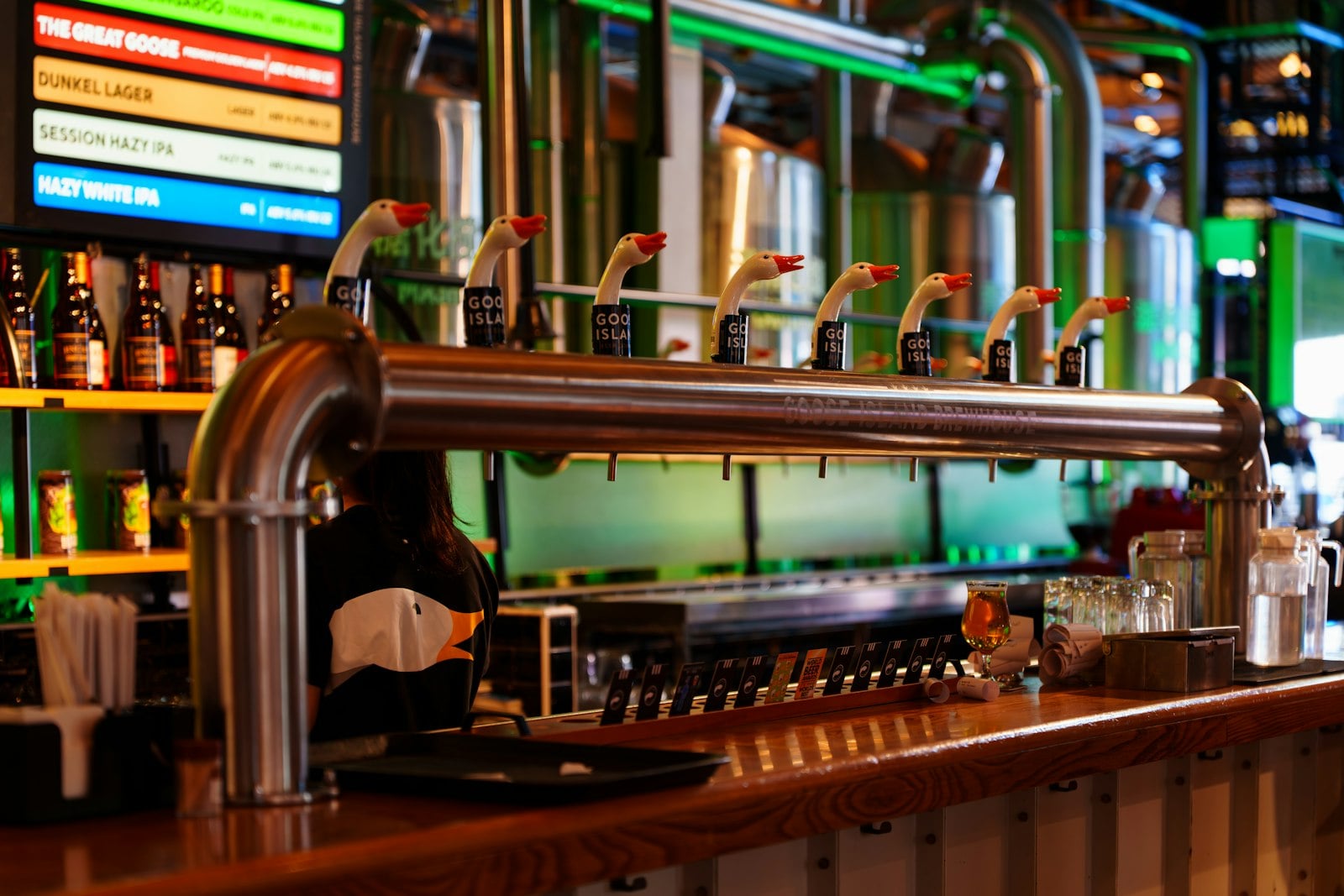 Beer taps and bottles behind a taproom bar