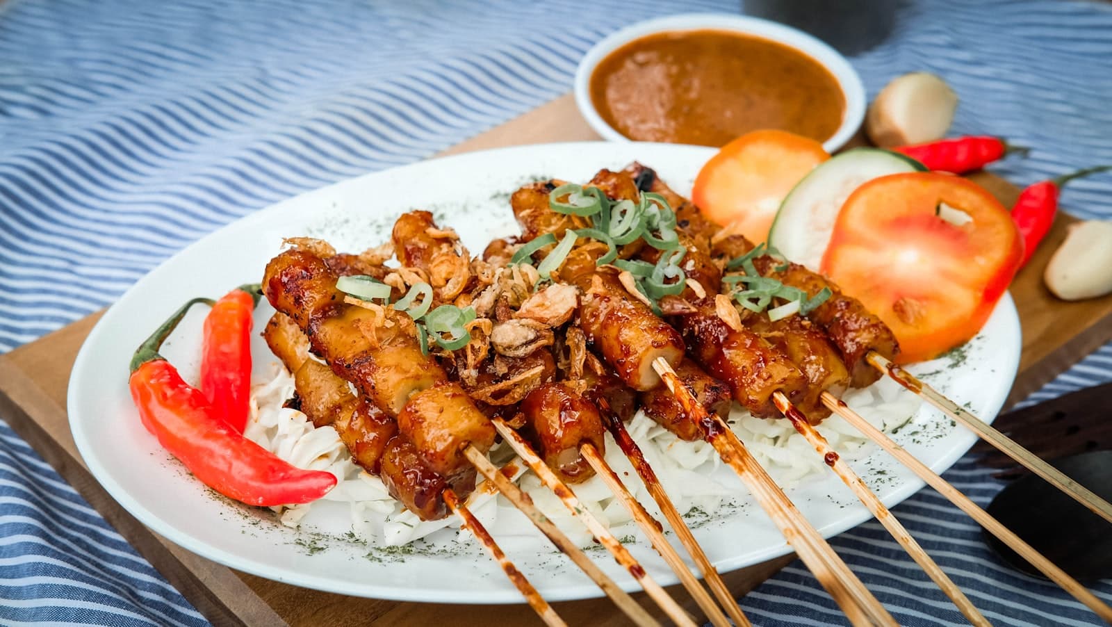 A Filipino grilled pork skewer and rice plate on a counter