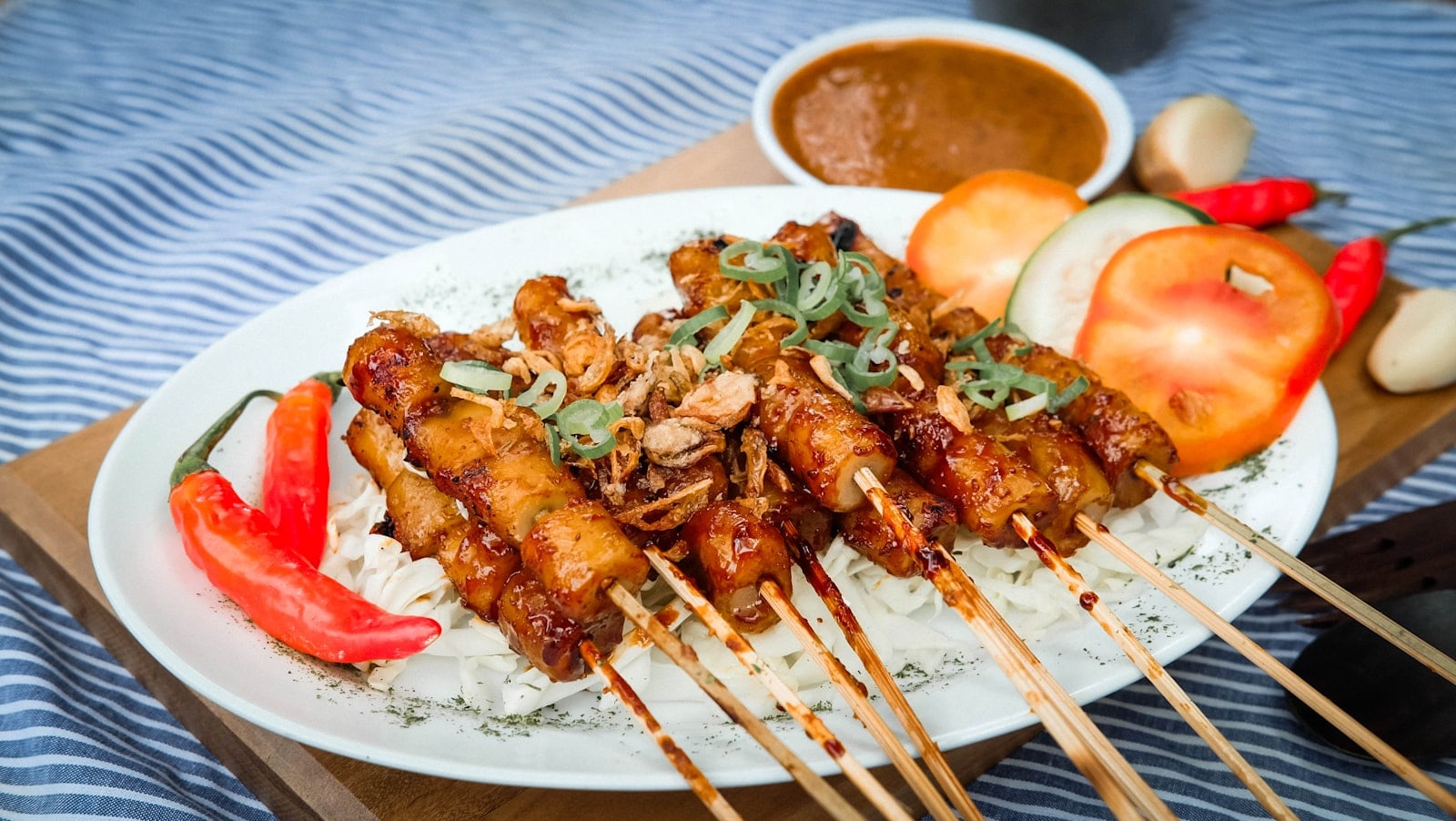 A Filipino grilled pork skewer and rice plate on a counter
