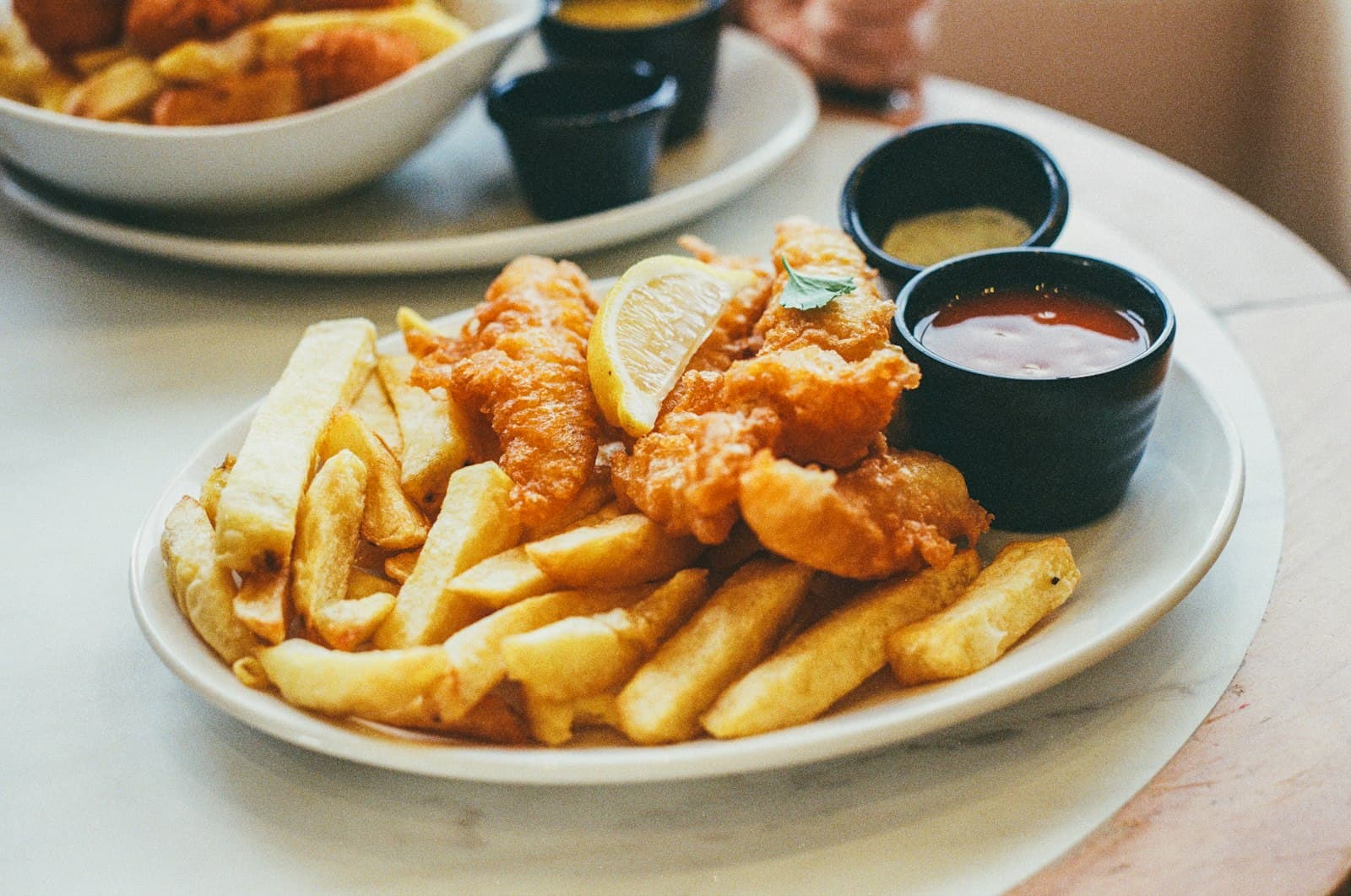 A dinner table in Pacific Beach with seafood and pizza