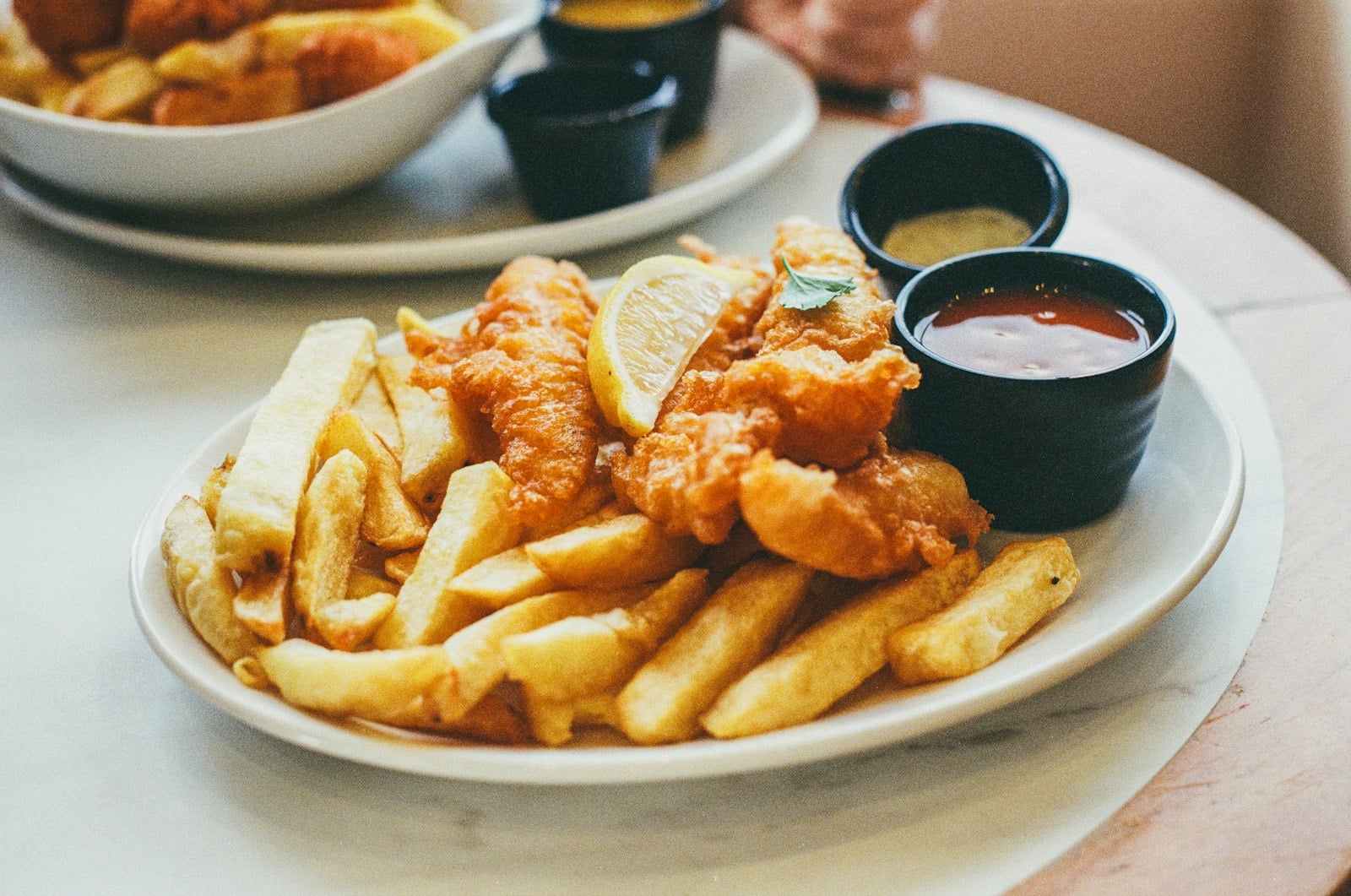 A dinner table in Pacific Beach with seafood and pizza