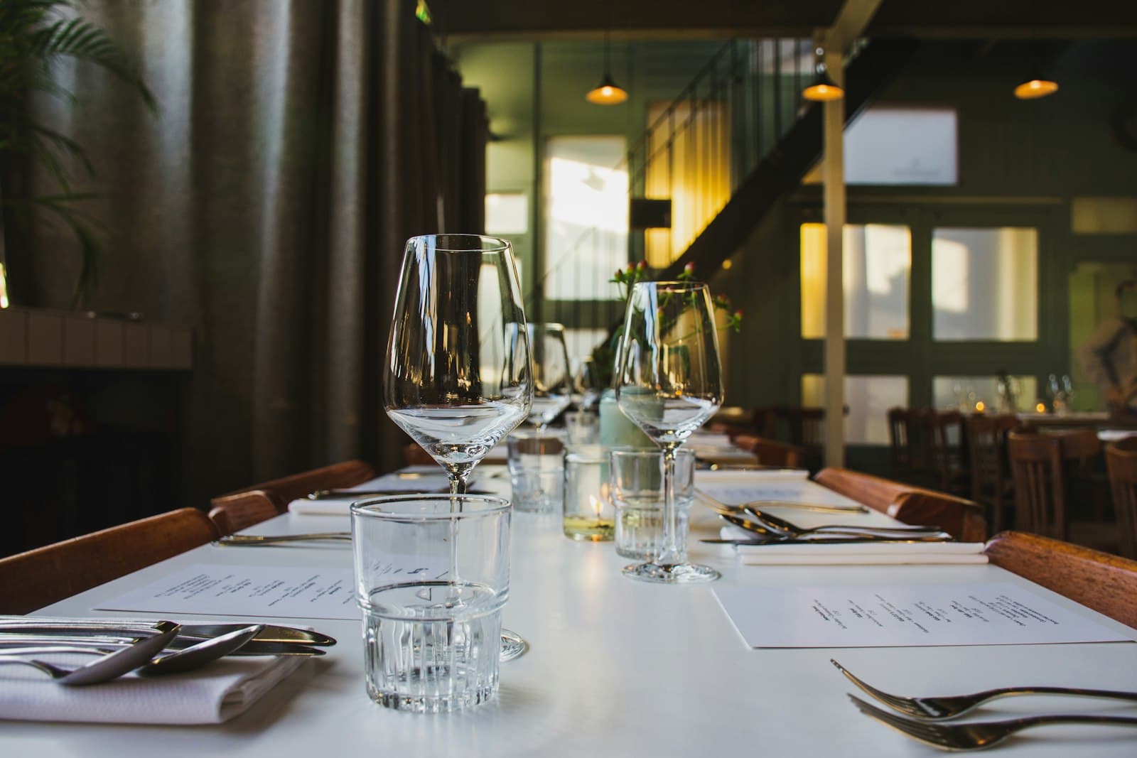 A long dining table set with wine glasses in a private restaurant room
