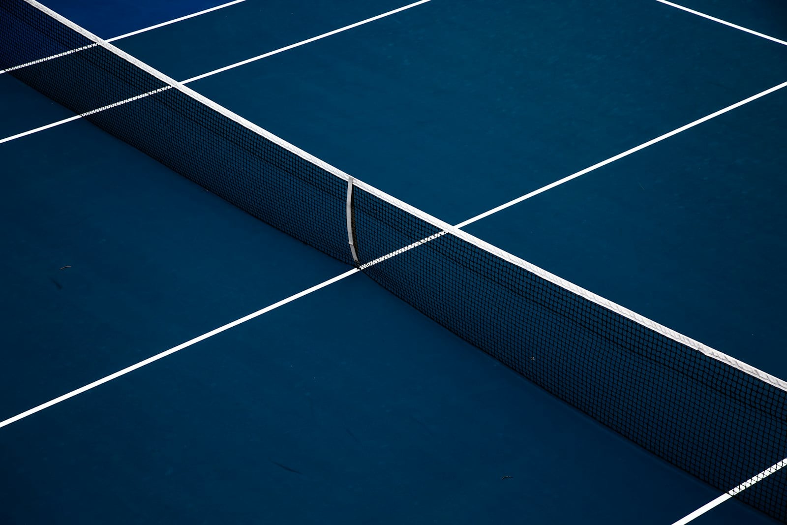 An empty blue hard court with white lines