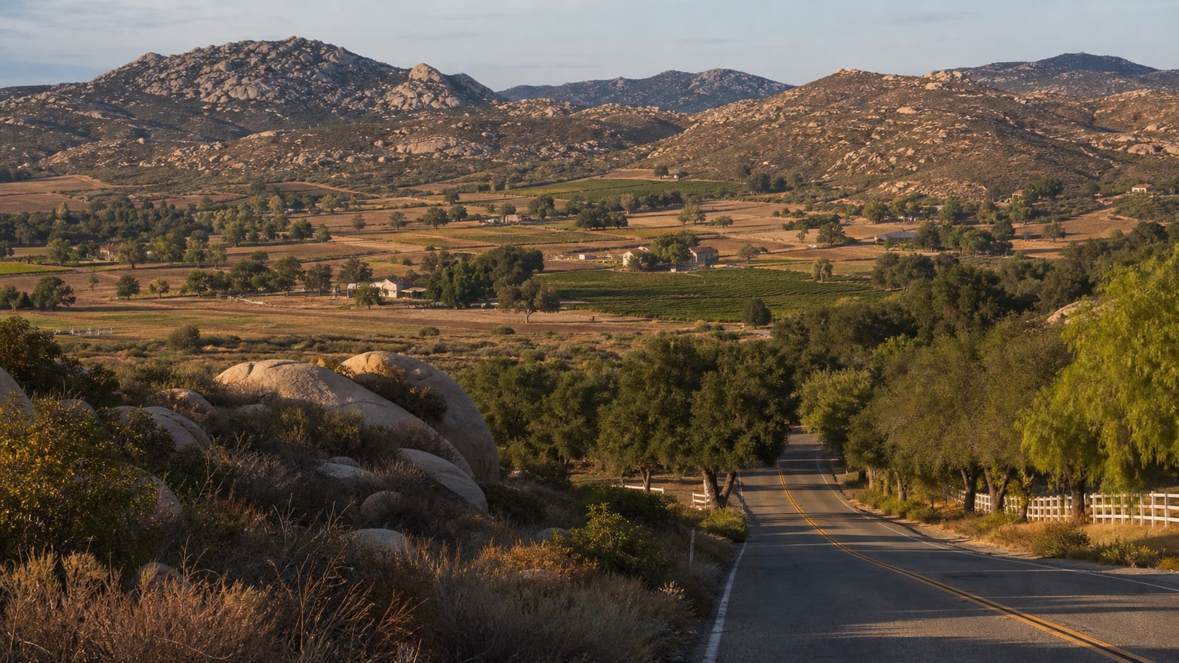 A rural Ramona valley of vineyards, roads, and granite hills