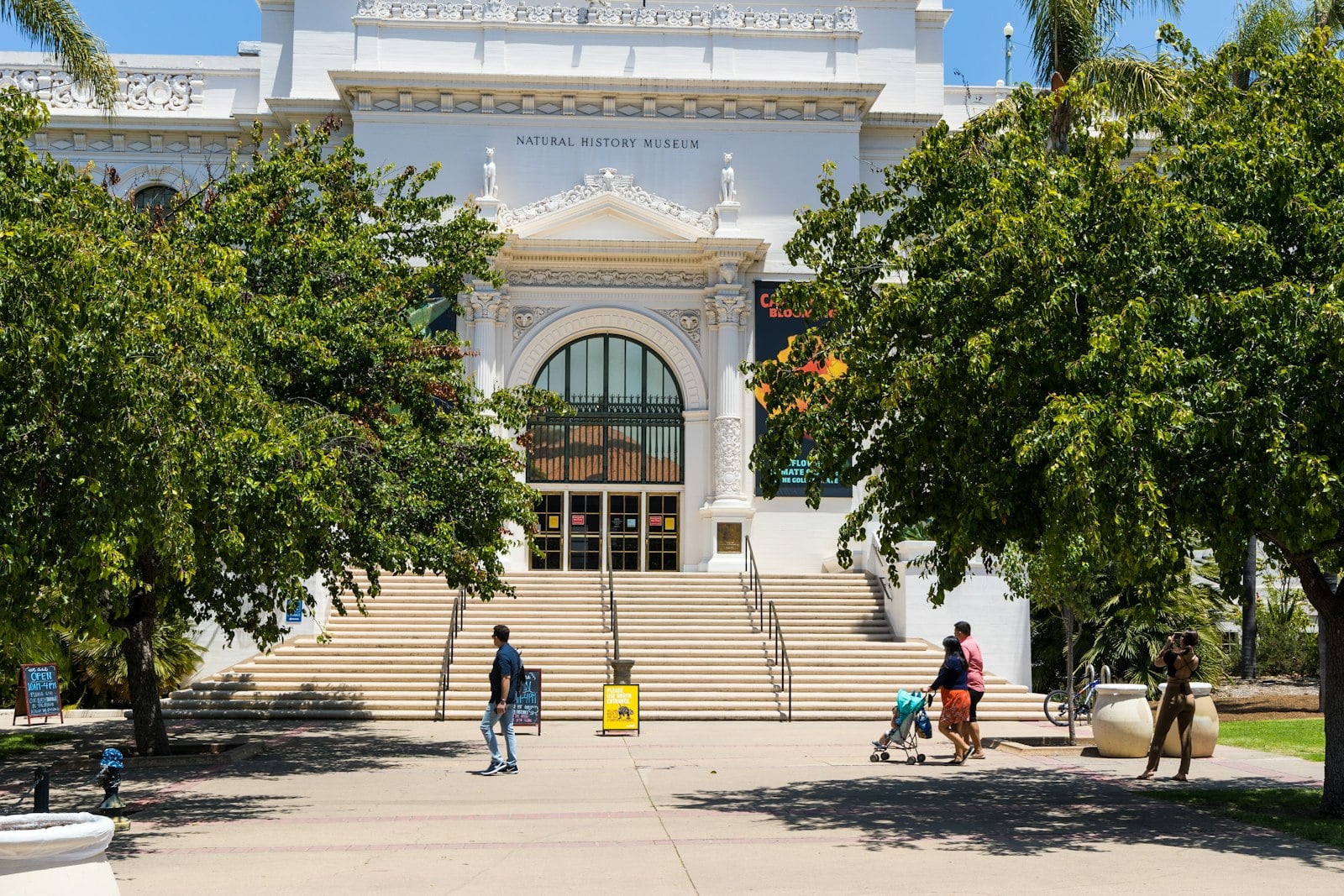 Families walking past the San Diego Natural History Museum in Balboa Park