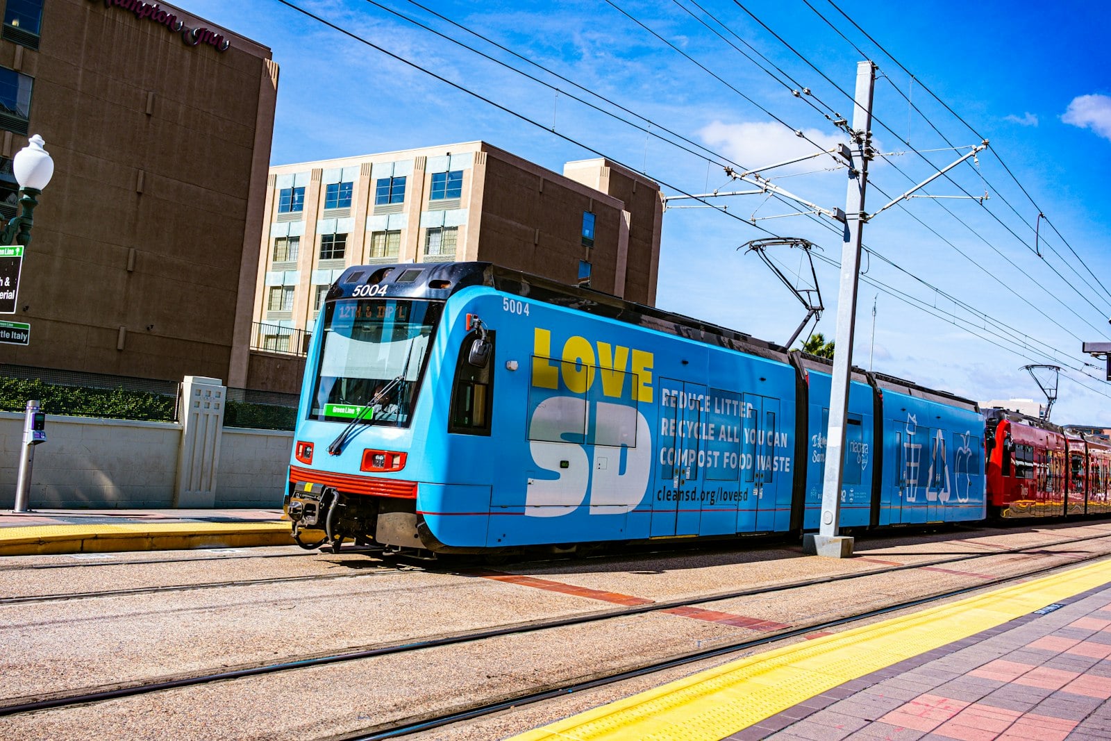 A blue San Diego Trolley stopped at the 12th and Imperial Transit Center