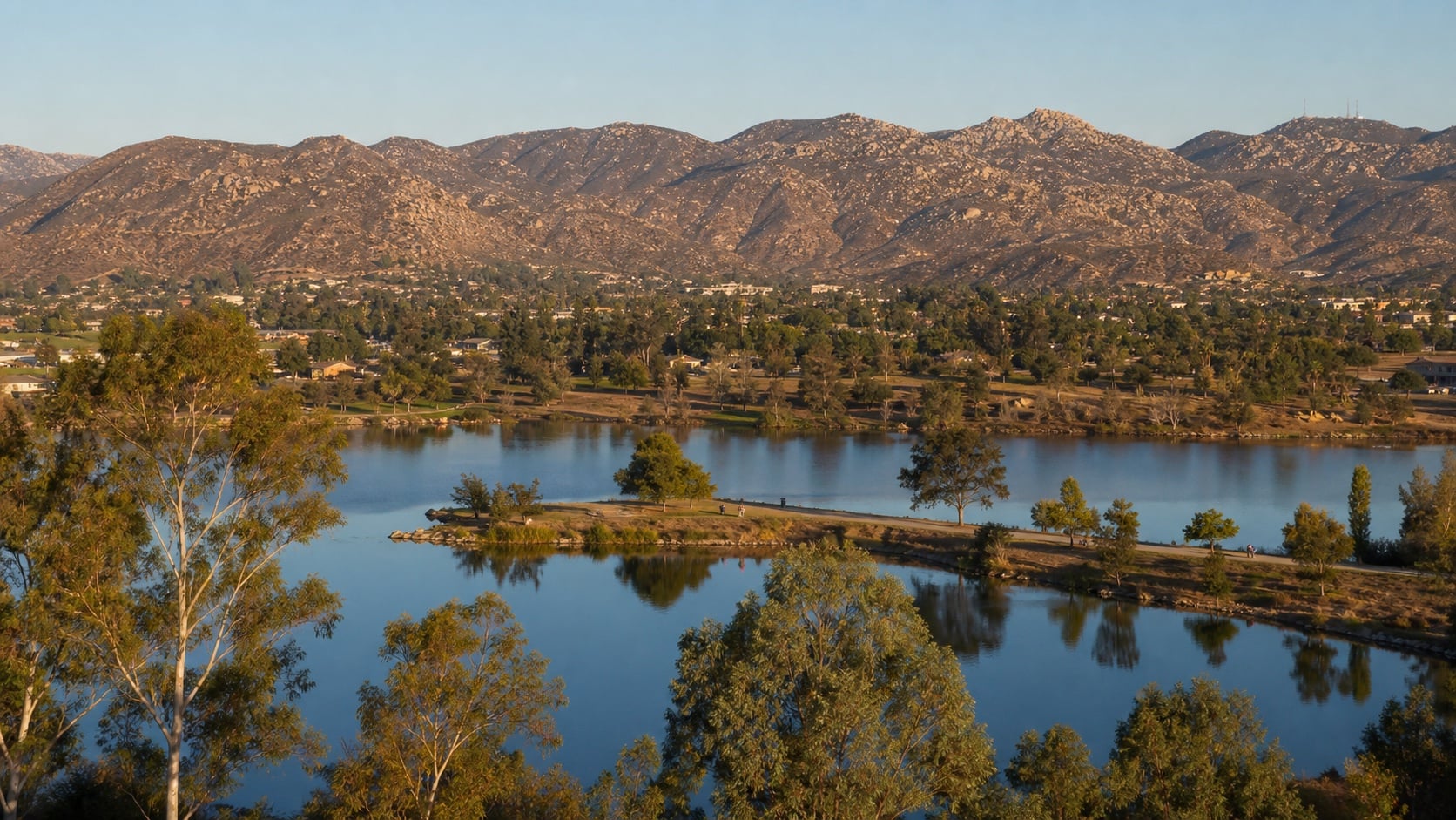 Blue lakes below Santee's granite foothills in late-day light
