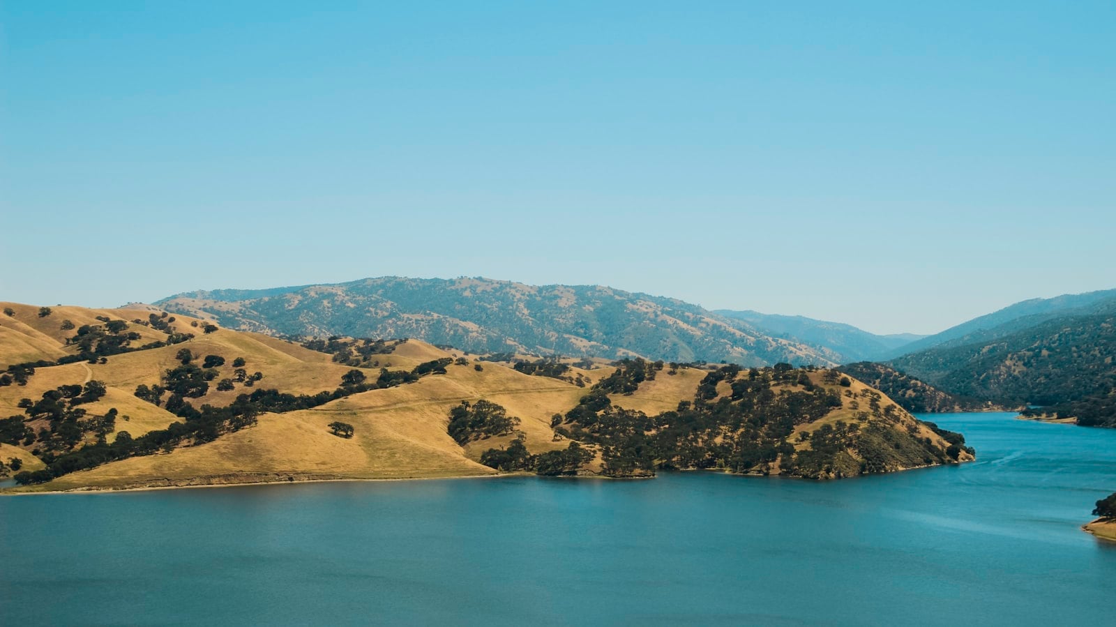 Blue lakes below Santee's granite foothills in late-day light