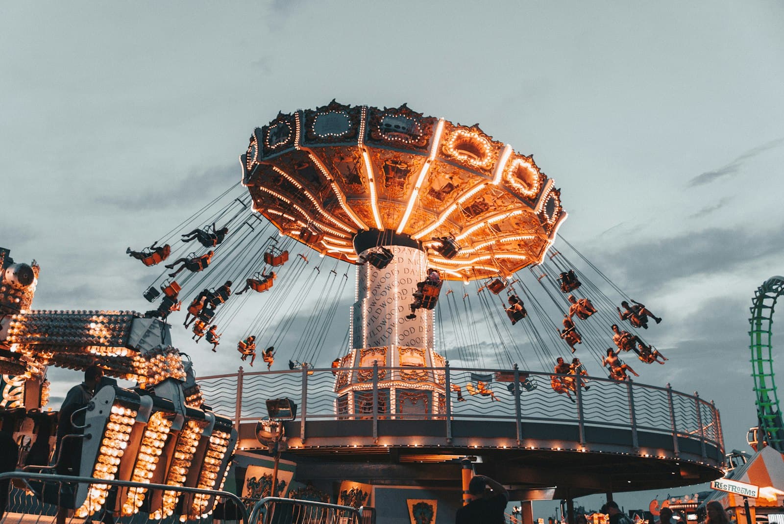 People riding an amusement park ride against an open sky