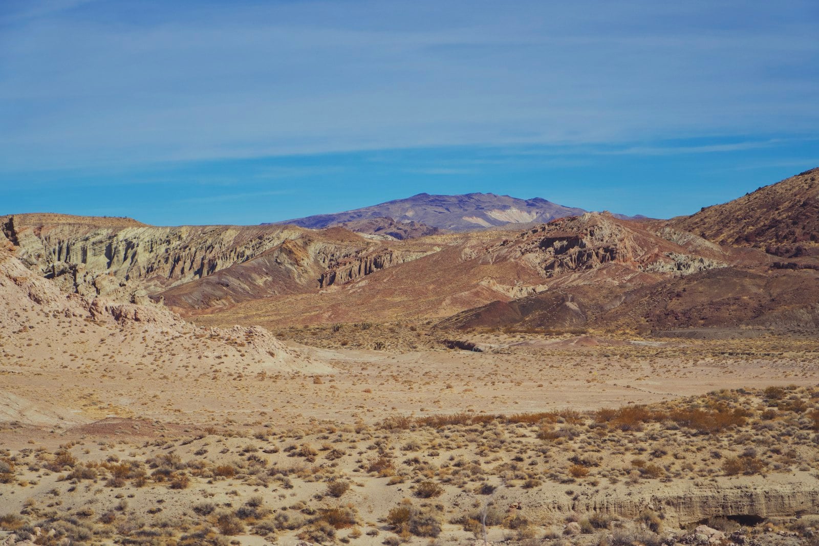 Dry chaparral hillsides and ridgelines under a wide inland sky