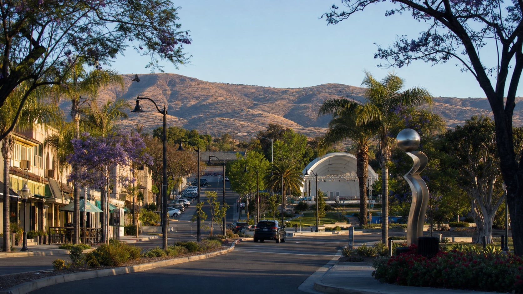 Downtown Vista street leading toward an outdoor stage and inland hills